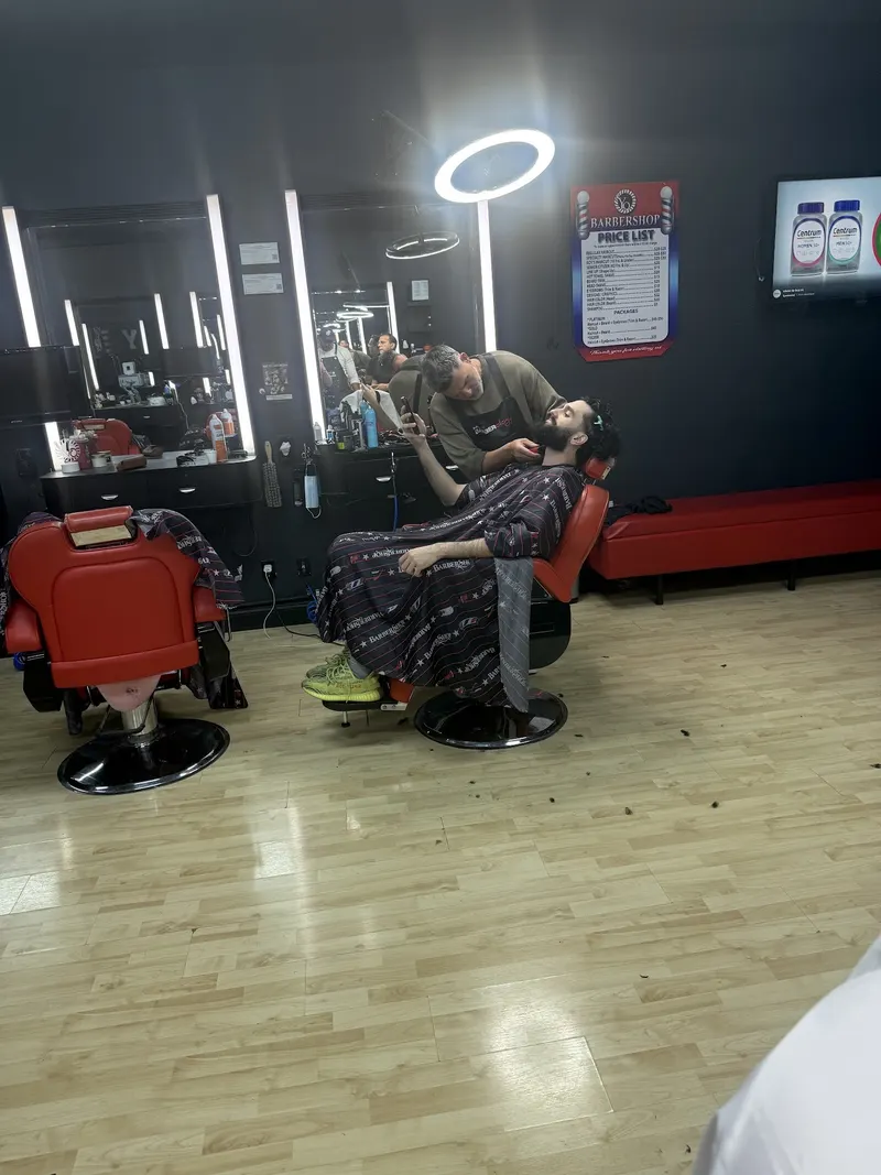 Red barber chairs and mirrors with a ring light